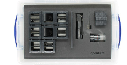 A gray UC2 Minibox with various optical components such as lenses and mirrors, designed for microscopy and imaging experiments.
