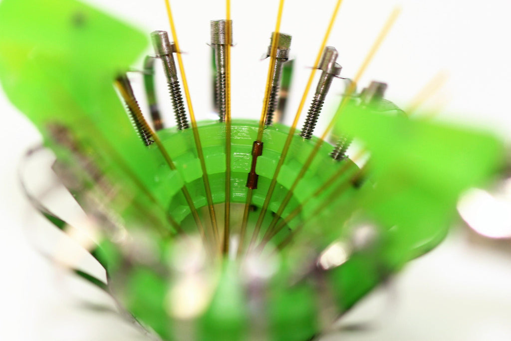 A detailed image of the flexDrive, showing a green circuit board with multiple metallic components and wiring.